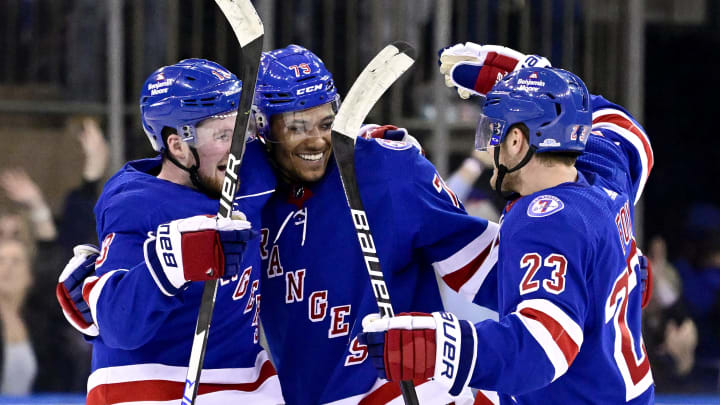 NEW YORK, NEW YORK – FEBRUARY 15: K’Andre Miller #79 of the New York Rangers is congratulated by Alexis Lafreniere #13 and Adam Fox #23 after scoring the game-winning shootout goal against the Boston Bruins at Madison Square Garden on February 15, 2022 in New York City. (Photo by Steven Ryan/Getty Images)