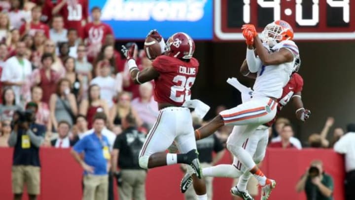 Sep 20, 2014; Tuscaloosa, AL, USA; Alabama Crimson Tide defensive back Landon Collins (26) intercepts a pass intended for Florida Gators wide receiver Quinton Dunbar (1) in the fourth quarter of their game at Bryant-Denny Stadium. Alabama won 42-21. Mandatory Credit: Jason Getz-USA TODAY Sports