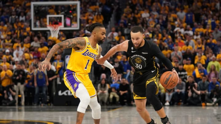 May 2, 2023; San Francisco, California, USA; Golden State Warriors guard Stephen Curry (30) dribbles next to Los Angeles Lakers guard D'Angelo Russell (1) in the fourth quarter during game one of the 2023 NBA playoffs at the Chase Center. Mandatory Credit: Cary Edmondson-USA TODAY Sports