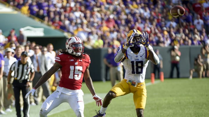 Sep 3, 2016; Green Bay, WI, USA; LSU Tigers cornerback Tre’Davious White (18) intercepts a pass intended for Wisconsin Badgers wide receiver Robert Wheelwright (15) and returns it for a touchdown in the 3rd quarter at Lambeau Field. Mandatory Credit: Benny Sieu-USA TODAY Sports