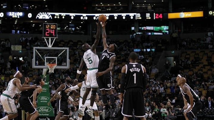 Oct 16, 2012; Boston, Massachusetts, USA; Boston Celtics forward/center Kevin Garnett (5) and Brooklyn Nets forward center Andray Blatche (0) battle for the tip off during the first quarter at TD Banknorth Garden. Mandatory Credit: Greg M. Cooper-USA TODAY Sports