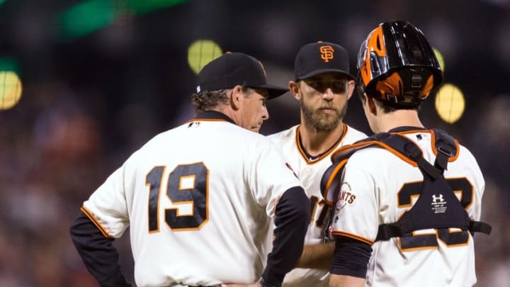 Aug 18, 2016; San Francisco, CA, USA; San Francisco Giants pitching coach Dave Righetti (19) and starting pitcher Madison Bumgarner (40) and catcher Buster Posey (28) talk before the pitch against the New York Mets in the fourth inning at AT&T Park. Mandatory Credit: John Hefti-USA TODAY Sports