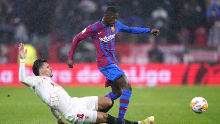 Karim Rekik competes for the ball with Ousmane Dembele during the LaLiga match between Sevilla FC and FC Barcelona at Estadio Ramon Sanchez Pizjuan on December 21, 2021 in Seville, Spain. (Photo by Mateo Villalba/Quality Sport Images/Getty Images)