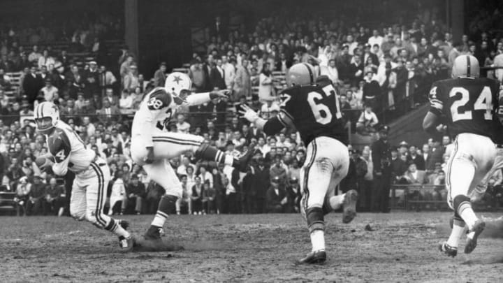 PITTSBURGH - OCTOBER 21: Eddie LeBaron #14 of the Dallas Cowboys rolls out on a fake punt executed by Sam Baker #38 against Bob Schmitz #67 and Johnny Sample #24 of the Pittsburgh Steelers during the game at Pitt Stadium on October 21, 1962 in Pittsburgh, Pennsylvania. (Photo by Robert Riger/Getty Images)