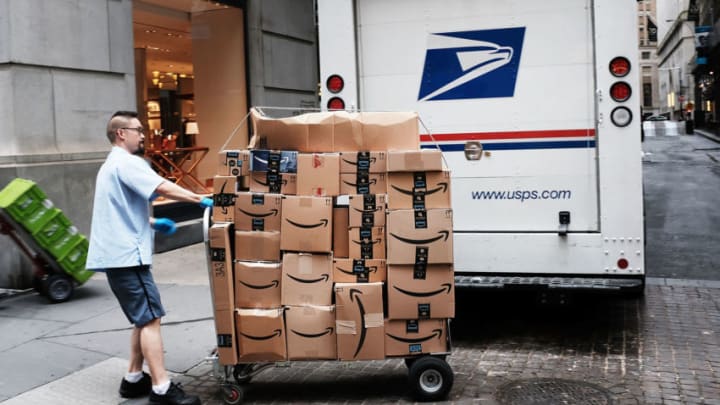 NEW YORK, NY - OCTOBER 11: A US Postal worker delivers Amazon boxes outside of the New York Stock Exchange (NYSE) on October 11, 2018 in New York City. Following a massive sell-off of over 800 points yesterday, the Dow Jones Industrial Average fell over 100 points in morning trading. (Photo by Spencer Platt/Getty Images)