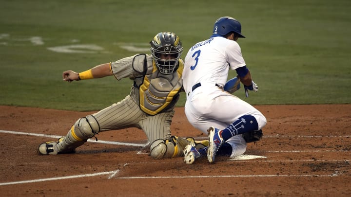 LOS ANGELES, CA – AUGUST 11: Catcher Austin Hedges #18 of the San Diego Padres tags out Chris Taylor #3 of the Los Angeles Dodgers at home plate as he tried to score on double by Enrique Hernandez #14 during the second inning at Dodger Stadium on August 11, 2020 in Los Angeles, California. (Photo by Kevork Djansezian/Getty Images)