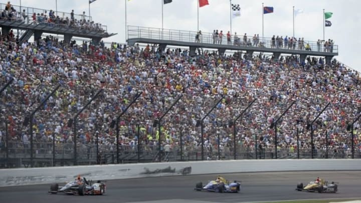 May 29, 2016; Indianapolis, IN, USA; IndyCar Series driver Alex Tagliani (35) , driver Alexander Rossi (98) and driver James Hinchcliffe (5) race in turn one during the 100th running of the Indianapolis 500 at Indianapolis Motor Speedway. Mandatory Credit: Michael Madrid-USA TODAY Sports