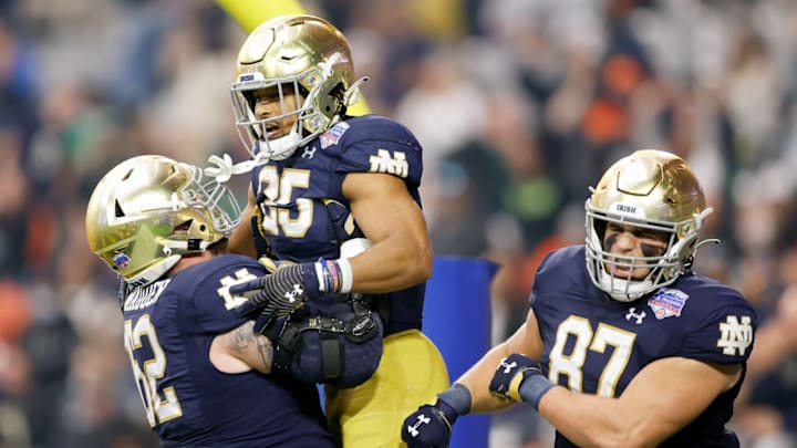 GLENDALE, ARIZONA – JANUARY 01: Chris Tyree #25 of the Notre Dame Fighting Irish celebrates with teammates after scoring a touchdown in the first quarter against the Oklahoma State Cowboys during the PlayStation Fiesta Bowl at State Farm Stadium on January 01, 2022, in Glendale, Arizona. (Photo by Christian Petersen/Getty Images)