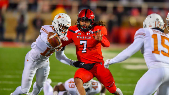 LUBBOCK, TX - NOVEMBER 10: Jett Duffey #7 of the Texas Tech Red Raiders tries to get past Davante Davis #18 of the Texas Longhorns during the 2nd half of the game on November 10, 2018 at Jones AT&T Stadium in Lubbock, Texas. Texas defeated Texas Tech 41-34. (Photo by John Weast/Getty Images)