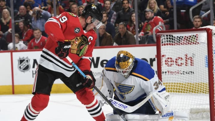 CHICAGO, IL - OCTOBER 13: Jake Allen #34 of the St. Louis Blues makes a stop on Jonathan Toews #19 of the Chicago Blackhawks during the first period at the United Center on October 13, 2018 in Chicago, Illinois. (Photo by Bill Smith/NHLI via Getty Images)