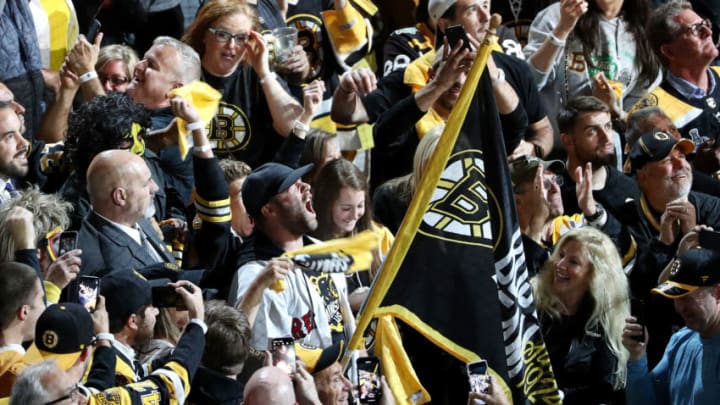 BOSTON, MASSACHUSETTS - JUNE 12: Aly Raisman and Julian Edelman wave the Boston Bruins flag prior to Game Seven of the 2019 NHL Stanley Cup Final between the Boston Bruins and the St. Louis Blues at TD Garden on June 12, 2019 in Boston, Massachusetts. (Photo by Patrick Smith/Getty Images)