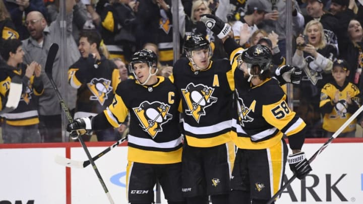 PITTSBURGH, PA - FEBRUARY 16: Pittsburgh Penguins Center Sidney Crosby (87) celebrates his power play goal with Pittsburgh Penguins Center Evgeni Malkin (71) and Pittsburgh Penguins Defenseman Kris Letang (58) during the second period in the NHL game between the Pittsburgh Penguins and the Calgary Flames on February 16, 2019, at PPG Paints Arena in Pittsburgh, PA. (Photo by Jeanine Leech/Icon Sportswire via Getty Images)