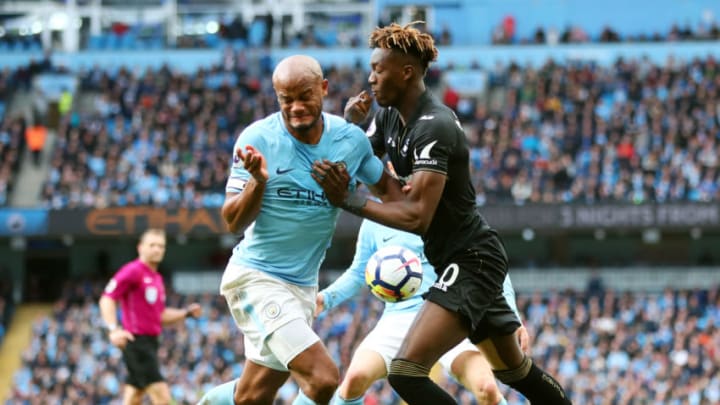 MANCHESTER, ENGLAND - APRIL 22: Vincent Kompany of Manchester City and Tammy Abraham of Swansea City clash during the Premier League match between Manchester City and Swansea City at Etihad Stadium on April 22, 2018 in Manchester, England. (Photo by Clive Brunskill/Getty Images)