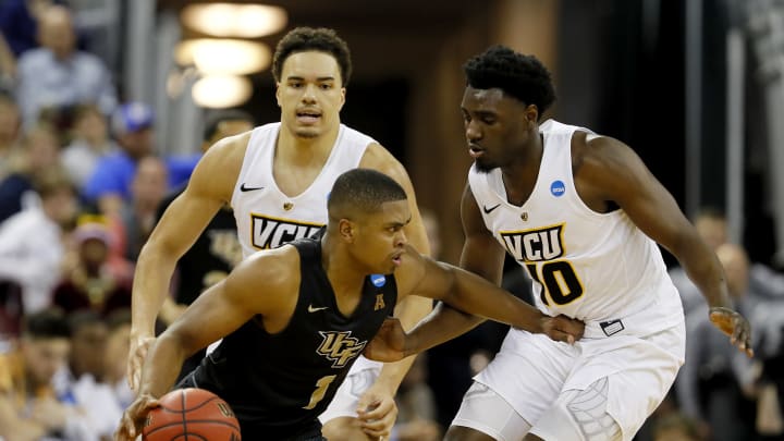 COLUMBIA, SOUTH CAROLINA – MARCH 22: B.J. Taylor #1 of the UCF Knights is defended by Marcus Santos-Silva #14 and Vince Williams #10 of the Virginia Commonwealth Rams in the first half during the first round of the 2019 NCAA Men’s Basketball Tournament at Colonial Life Arena on March 22, 2019 in Columbia, South Carolina. (Photo by Kevin C. Cox/Getty Images)