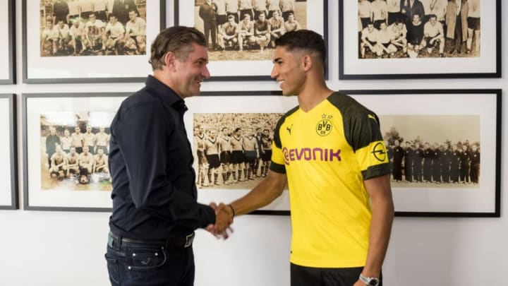 DORTMUND, GERMANY - JULY 11: Achraf Hakimi signs a new contract with Borussia Dortmund and Michael Zorc (sports director of Borussia Dortmund) at Dortmund on July 11, 2018 in Dortmund, Germany. (Photo by Alexandre Simoes/Borussia Dortmund/Getty Images)