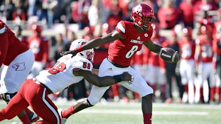Oct 22, 2016; Louisville, KY, USA; Louisville Cardinals quarterback Lamar Jackson (8) runs the ball against North Carolina State Wolfpack linebacker Airius Moore (58) during the first quarter at Papa John