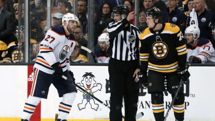 BOSTON, MA - NOVEMBER 26: Edmonton Oilers left wing Milan Lucic (27) moved away from Boston Bruins right defenseman Charlie McAvoy (73) by linesman Ryan Galloway (82) during a game between the Boston Bruins and the Edmonton Oilers on November 26, 2017, at TD Garden in Boston, Massachusetts. The Oilers defeated the Bruins 4-2. (Photo by Fred Kfoury III/Icon Sportswire via Getty Images)