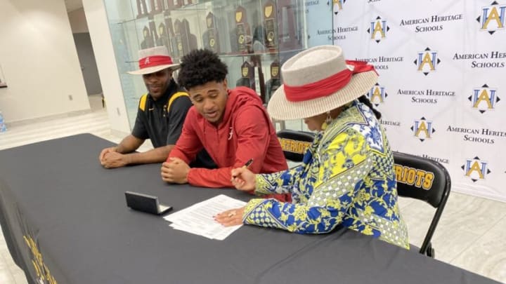 American Heritage star prospect Earl Little Jr. (center) signs with Alabama in a school ceremony on Dec. 15, 2021.Asdfasdfasdf