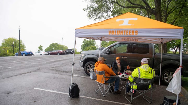 From left, Jared Haas, Megan Haas, and Terry Haas have a parking lot to themselves while tailgating before the start of the University of Tennessee’s Orange and White football game on Saturday, April 24, 2021. The family drive from Pennsylvania and Georgia to attend every Tennessee home game.Kns Vols Pre Spring Game