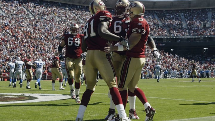 SAN FRANCISCO - OCTOBER 5: Jeff Garcia No. 5 and tackle Derrick Deese No. 63 congratulate wide receiver Terrell Owens No. 81 of the San Francisco 49ers after Owens' touchdown against the Detroit Lions on October 5, 2003 at 3 Com Park in San Francisco, California. The 49ers defeated the Lions 24-17. (Photo by Stephen Dunn/Getty Images)