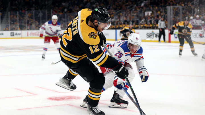 BOSTON, MASSACHUSETTS – OCTOBER 02: Libor Hajek #25 of the New York Rangers and Craig Smith #12 of the Boston Bruins battle for control of the puck during the third period of the preseason game at TD Garden on October 02, 2021 in Boston, Massachusetts. (Photo by Maddie Meyer/Getty Images)