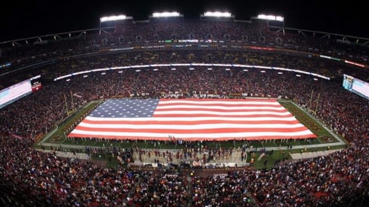 Nov 25, 2013; Landover, MD, USA; An american flag is unfurled during the national anthem prior to the game between the San Francisco 49ers and the Washington Redskins at FedEx Field. Mandatory Credit: Geoff Burke-USA TODAY Sports