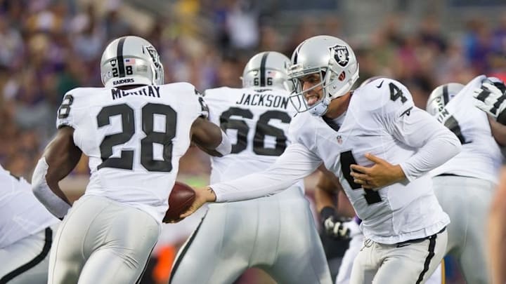 Aug 22, 2015; Minneapolis, MN, USA; Oakland Raiders quarterback Derek Carr (4) hands the ball to running back Latavius Murray (28) in the first quarter against the Minnesota Vikings at TCF Bank Stadium. Mandatory Credit: Brad Rempel-USA TODAY Sports