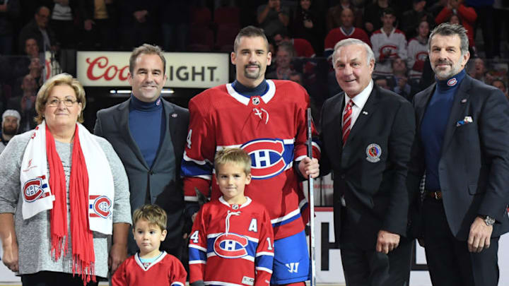 MONTREAL, QC - OCTOBER 17: Tomas Plekanec #14 of the Montreal Canadiens receives a silver hockey stick Geofffrom Guy Lafleur, Geoff Molson and Marc Bergevin for his 1000th NHL game during a pregame ceremony prior to the game against the St. Louis Blues at the Bell Centre on October 17, 2018 in Montreal, Quebec, Canada. (Photo by Francois Lacasse/NHLI via Getty Images)
