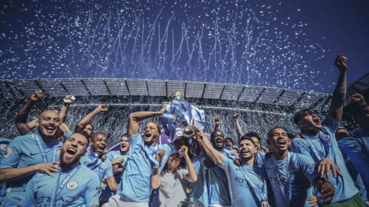 MANCHESTER, ENGLAND - MAY 06: [Editor's note - digital filters were used in the creation of this image] Vincent Kompany and Sergio Aguero of Manchester City lift the Premier League trophy during the Premier League match between Manchester City and Huddersfield Town at Etihad Stadium on May 6, 2018 in Manchester, England. (Photo by Michael Regan/Getty Images)