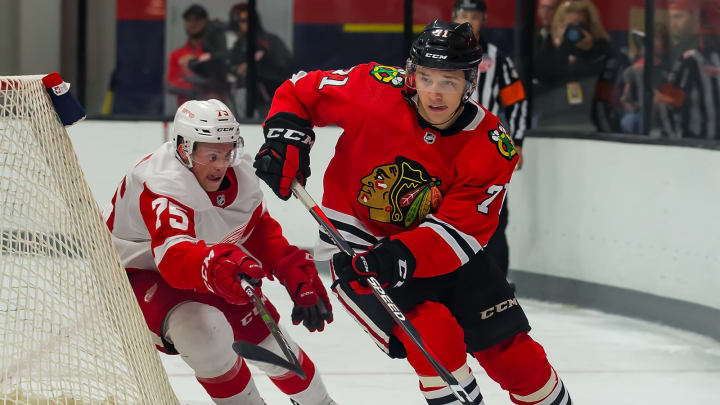 TRAVERSE CITY, MI – SEPTEMBER 06: Philipp Kurashev #71 of the Chicago Blackhawks skates around the net in front of Troy Loggins #75 of the Detroit Red Wings of the during Day-1 of the NHL Prospects Tournament at Centre Ice Arena on September 6, 2019 in Traverse City, Michigan. (Photo by Dave Reginek/NHLI via Getty Images) *** Philipp Kurashev; Troy Loggins
