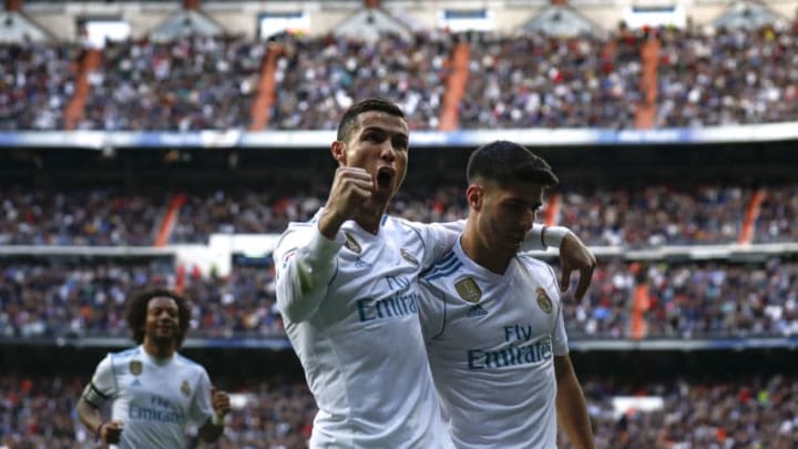 MADRID, SPAIN - DECEMBER 09: Cristiano Ronaldo (L) of Real Madrid CF celebrates scoring their second goal with teammate Marco Asensio (R) during the La Liga match between Real Madrid CF and Sevilla FC at Estadio Santiago Bernabeu on December 9, 2017 in Madrid, Spain . (Photo by Gonzalo Arroyo Moreno/Getty Images)