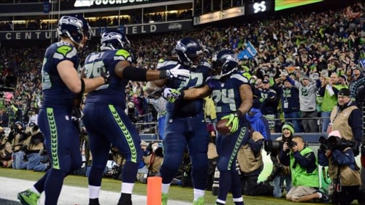 Jan 19, 2014; Seattle, WA, USA; Seattle Seahawks running back Marshawn Lynch (24) celebrates with teammates after scoring a touchdown against the San Francisco 49ers in the third quarter of the 2013 NFC Championship football game at CenturyLink Field. Mandatory Credit: Kyle Terada-USA TODAY Sports