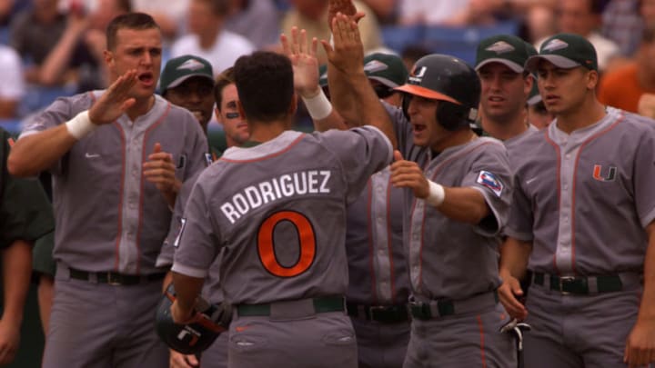 14 Jun 2001: Javy Rodriguez #0 of Miami is greeted by his teammates after scoring on a Kevin Brown home run in the fourth inning against Tennessee during the College World Series at Rosenblatt Stadium in Omaha, Nebraska. Miami won 12-6 to advance to the finals against Stanford. DIGITAL IMAGE Mandatory Credit: Andy Lyons/ALLSPORT