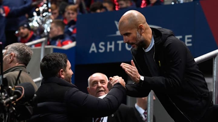 BRISTOL, ENGLAND - JANUARY 23: Manchester City manager Pep Guardiola (r) shakes hands with Bristol City manager Gary Johnson before the Carabao Cup Semi-Final: Second Leg match between Bristol City and Manchester City at Ashton Gate on January 23, 2018 in Bristol, England. (Photo by Stu Forster/Getty Images)
