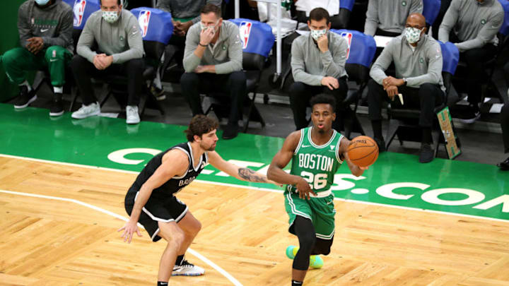 BOSTON, MASSACHUSETTS - DECEMBER 18: Aaron Nesmith #26 of the Boston Celtics makes a pass around Joe Harris #12 of the Brooklyn Nets during the preseason game at TD Garden on December 18, 2020 in Boston, Massachusetts. NOTE TO USER: User expressly acknowledges and agrees that, by downloading and or using this photograph, User is consenting to the terms and conditions of the Getty Images License Agreement. (Photo by Maddie Meyer/Getty Images)