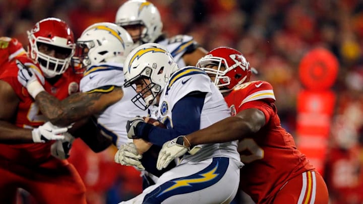 KANSAS CITY, MISSOURI - DECEMBER 13: Quarterback Philip Rivers #17 of the Los Angeles Chargers is sacked by defensive end Chris Jones #95 of the Kansas City Chiefs during the game at Arrowhead Stadium on December 13, 2018 in Kansas City, Missouri. (Photo by David Eulitt/Getty Images)