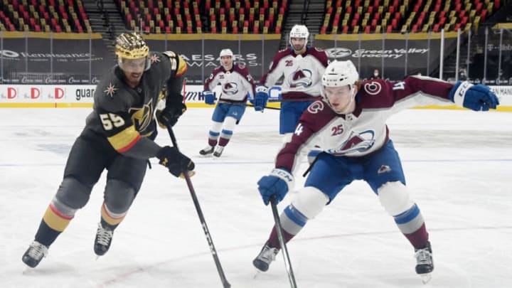 LAS VEGAS, NEVADA - FEBRUARY 16: Keegan Kolesar #55 of the Vegas Golden Knights and Bowen Byram #4 of the Colorado Avalanche go after the puck in the second period of their game at T-Mobile Arena on February 16, 2021 in Las Vegas, Nevada. The Avalanche defeated the Golden Knights 3-2. (Photo by Ethan Miller/Getty Images)