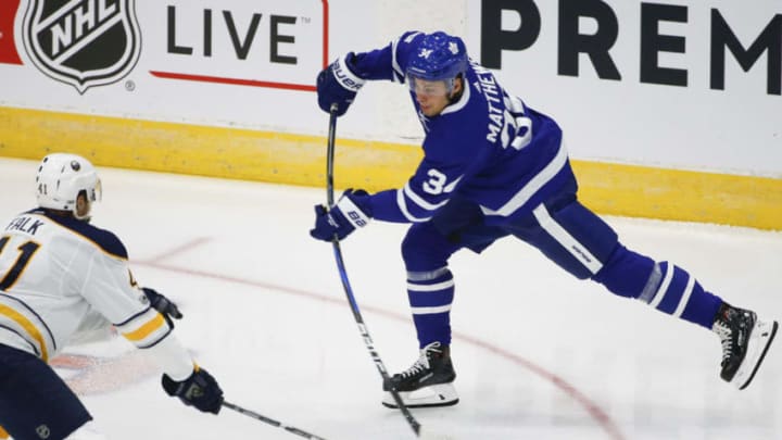 TORONTO, ON - SEPTEMBER 22 - Leafs' Auston Matthews shoots the puck past Sabres' Justin Falk in 1st period action as the Toronto Maple Leafs host the Buffalo Sabres in pre-season action at Ricoh Coliseum, Toronto. September 22, 2017. (Bernard Weil/Toronto Star via Getty Images)