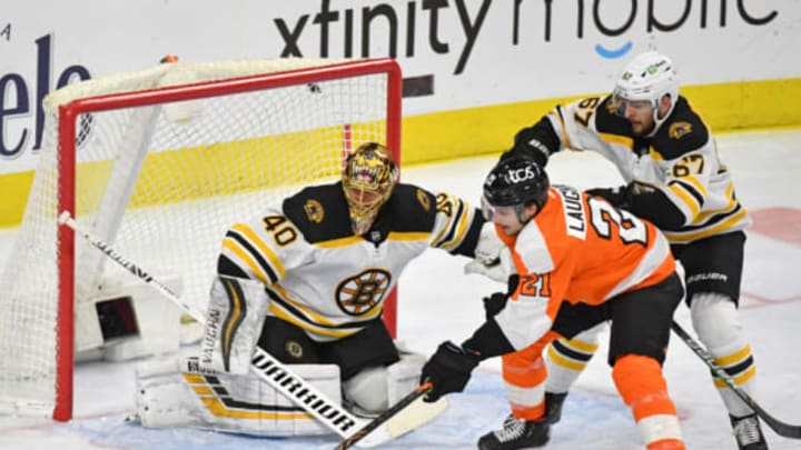 Feb 5, 2021; Philadelphia, Pennsylvania, USA; Philadelphia Flyers left wing Scott Laughton (21) is defended by Boston Bruins defenseman Jakub Zboril (67) in front of goaltender Tuukka Rask (40) during the third period at Wells Fargo Center. Mandatory Credit: Eric Hartline-USA TODAY Sports