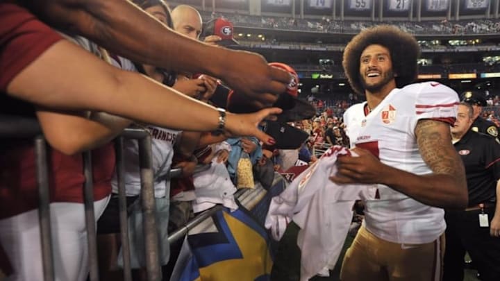 Sep 1, 2016; San Diego, CA, USA; San Francisco 49ers quarterback Colin Kaepernick (7) reacts while signing autographs after the game against the San Diego Chargers at Qualcomm Stadium. San Francisco won 31-21. Mandatory Credit: Orlando Ramirez-USA TODAY Sports