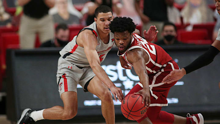 Feb 1, 2021; Lubbock, Texas, USA; Texas Tech Red Raiders guard Kevin McCullar (15) tries to steal the ball from Oklahoma Sooners guard Elijah Harkless (24) in the first half at United Supermarkets Arena. Mandatory Credit: Michael C. Johnson-USA TODAY Sports