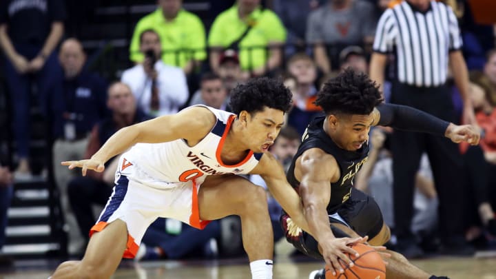 CHARLOTTESVILLE, VA – JANUARY 05: Kihei Clark #0 of the Virginia Cavaliers and David Nichols #11 of the Florida State Seminoles reach for a loose ball in the first half during a game at John Paul Jones Arena on January 5, 2019 in Charlottesville, Virginia. (Photo by Ryan M. Kelly/Getty Images)