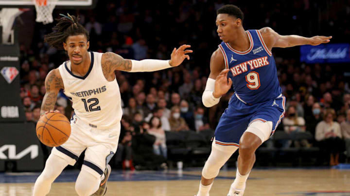 Feb 2, 2022; New York, New York, USA; Memphis Grizzlies guard Ja Morant (12) drives around New York Knicks guard RJ Barrett (9) during the third quarter at Madison Square Garden. Mandatory Credit: Brad Penner-USA TODAY Sports