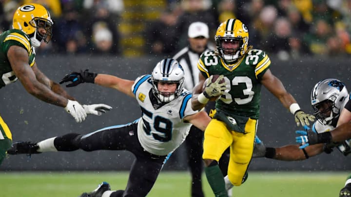 GREEN BAY, WISCONSIN - NOVEMBER 10: Aaron Jones #33 of the Green Bay Packers runs with the football in the second half against Luke Kuechly #59 of the Carolina Panthers at Lambeau Field on November 10, 2019 in Green Bay, Wisconsin. (Photo by Quinn Harris/Getty Images)