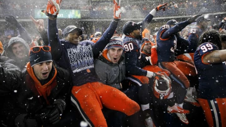 NEW YORK, NY - DECEMBER 29: Members of the Syracuse Orange celebrate with fans after their win over the West Virginia Mountaineers in the New Era Pinstripe Bowl at Yankee Stadium on December 29, 2012 in the Bronx borough of New York City. (Photo by Jeff Zelevansky/Getty Images)