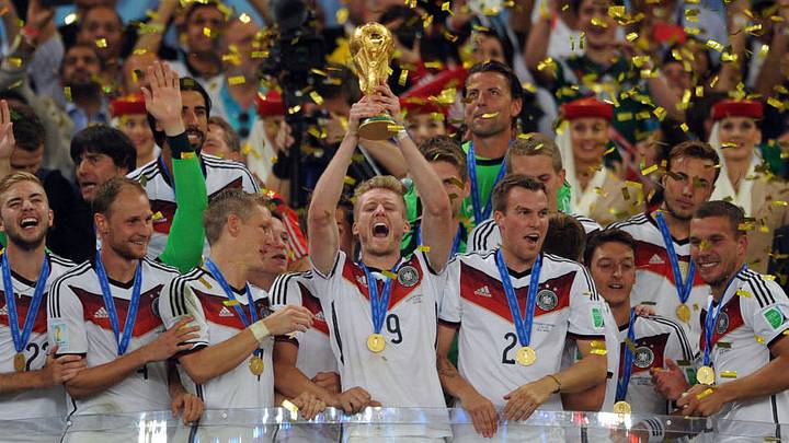 RIO DE JANEIRO, BRAZIL - JULY 13: Andre Schurrle of Germany lifts the trophy following the 2014 World Cup Final match between Germany and Argentina at Maracana Stadium on July 13, 2014 in Rio de Janeiro, Brazil. (Photo by Chris Brunskill Ltd/Getty Images)