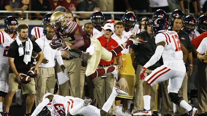 Sep 5, 2016; Orlando, FL, USA; Florida State Seminoles wide receiver Travis Rudolph (15) jumps as Mississippi Rebels defensive back Carlos Davis (23) and defensive back Tony Conner (12) defend in the first quarter at Camping World Stadium. Mandatory Credit: Logan Bowles-USA TODAY Sports