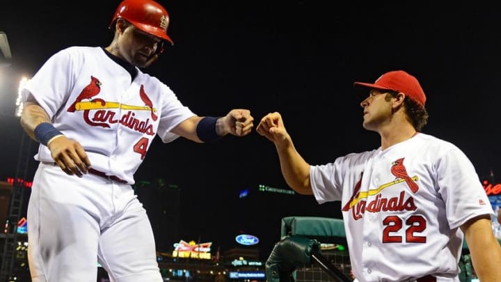 Aug 24, 2016; St. Louis, MO, USA; St. Louis Cardinals catcher Yadier Molina (4) is congratulated by manager Mike Matheny (22) after scoring during the seventh inning against the New York Mets at Busch Stadium. Mandatory Credit: Jeff Curry-USA TODAY Sports