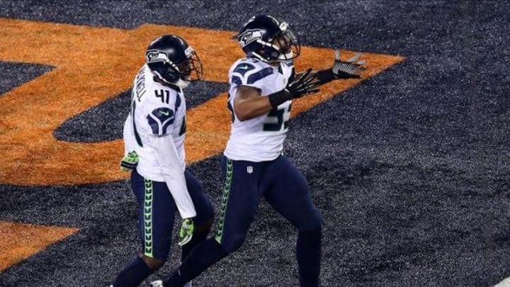 Feb 2, 2014; East Rutherford, NJ, USA; Seattle Seahawks outside linebacker Malcolm Smith (53) celebrates his touchdown with cornerback Byron Maxwell (41) against the Denver Broncos during the second quarter in Super Bowl XLVIII at MetLife Stadium. Mandatory Credit: Noah K. Murray-USA TODAY Sports