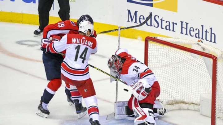 WASHINGTON, DC - APRIL 13: Carolina Hurricanes goaltender Petr Mrazek (34) makes a third period save on shot by Washington Capitals center Nicklas Backstrom (19) who is defended by right wing Justin Williams (14) on April 13, 2019, at the Capital One Arena in Washington, D.C. in the first round of the Stanley Cup Playoffs. (Photo by Mark Goldman/Icon Sportswire via Getty Images)